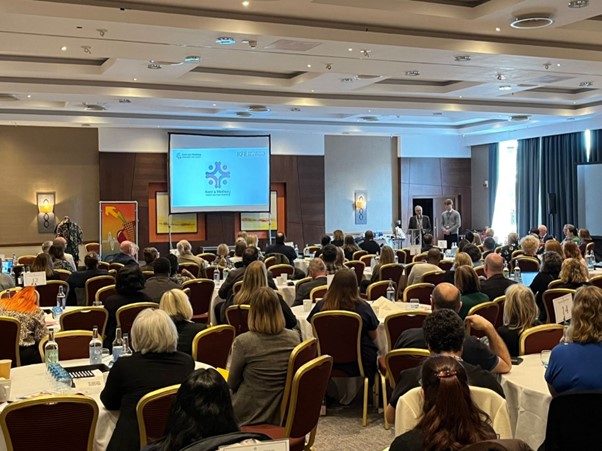 Photograph of presenter and audience at an Academy event